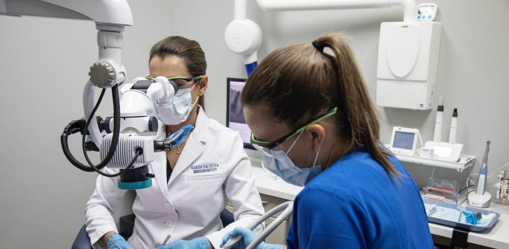 Dr. Karen Da Silva and staff working on an endodontic procedure